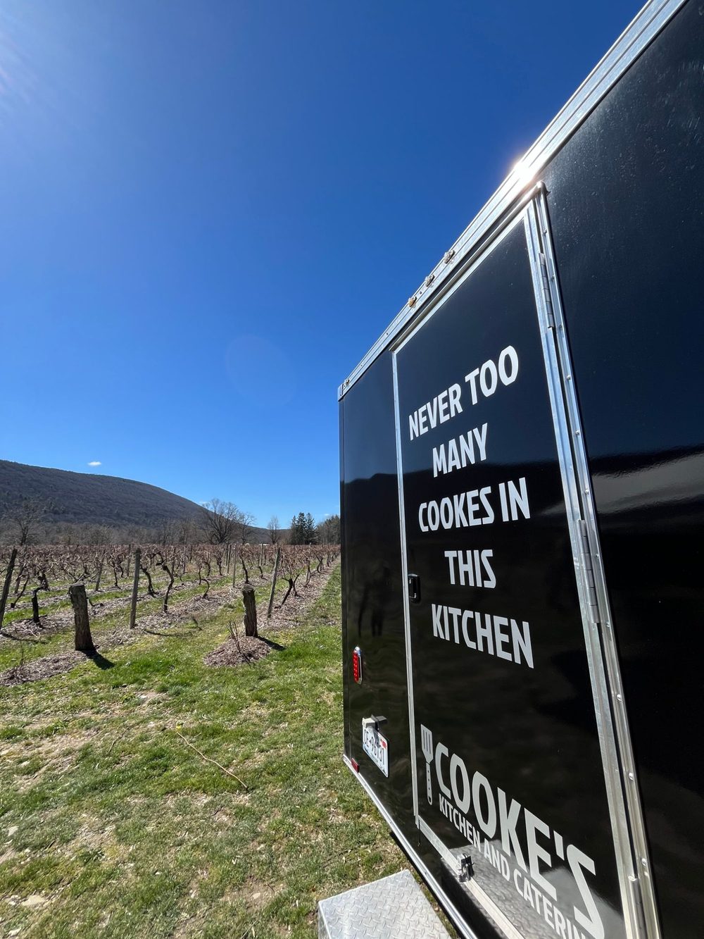 Cooke's Kitchen and Catering food trailer parked next to the vineyard at Heron Hill Winery in Naples, NY