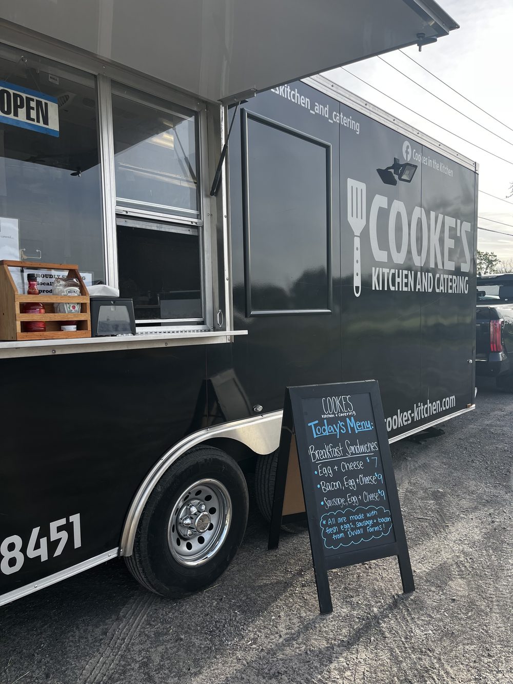 Cooke's Kitchen and Catering sandwich board listing the day's breakfast menu at the Farmers Market