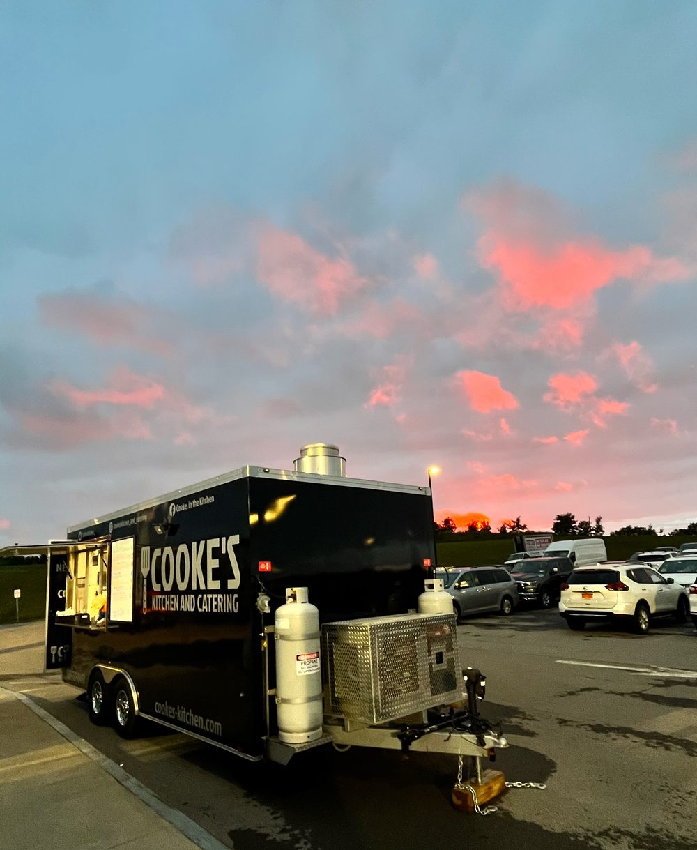 Cooke's Kitchen and Catering food truck at the Shootout for Soldiers event under a sunset sky